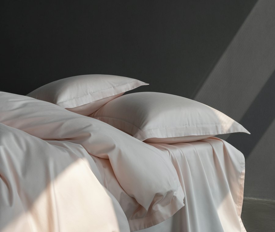 An autumn bed dressed with an eiderdown duvet, pillows and a throw